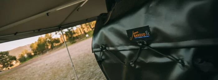 Detailed view of James Baroud Eco Bag effortlessly attached to the tire for ultimate outdoor convenience