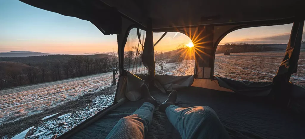 Jakub Fiser panoramic view from inside the tent on a snowy sunset