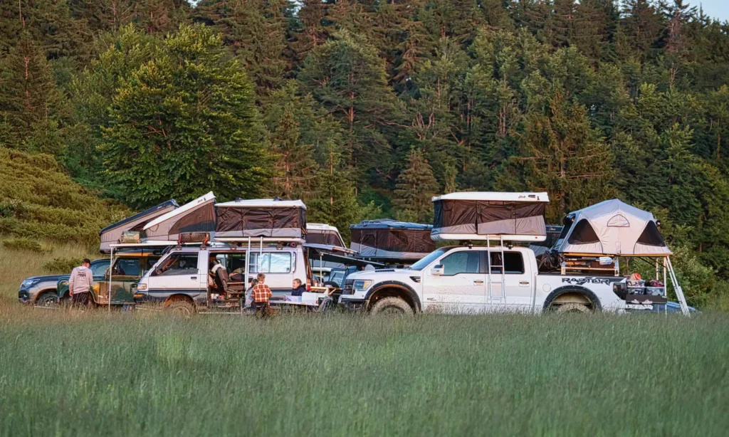 Baltic Overlander with Multiple Rooftop Tents in a Green Field During Their Expedition to Romania