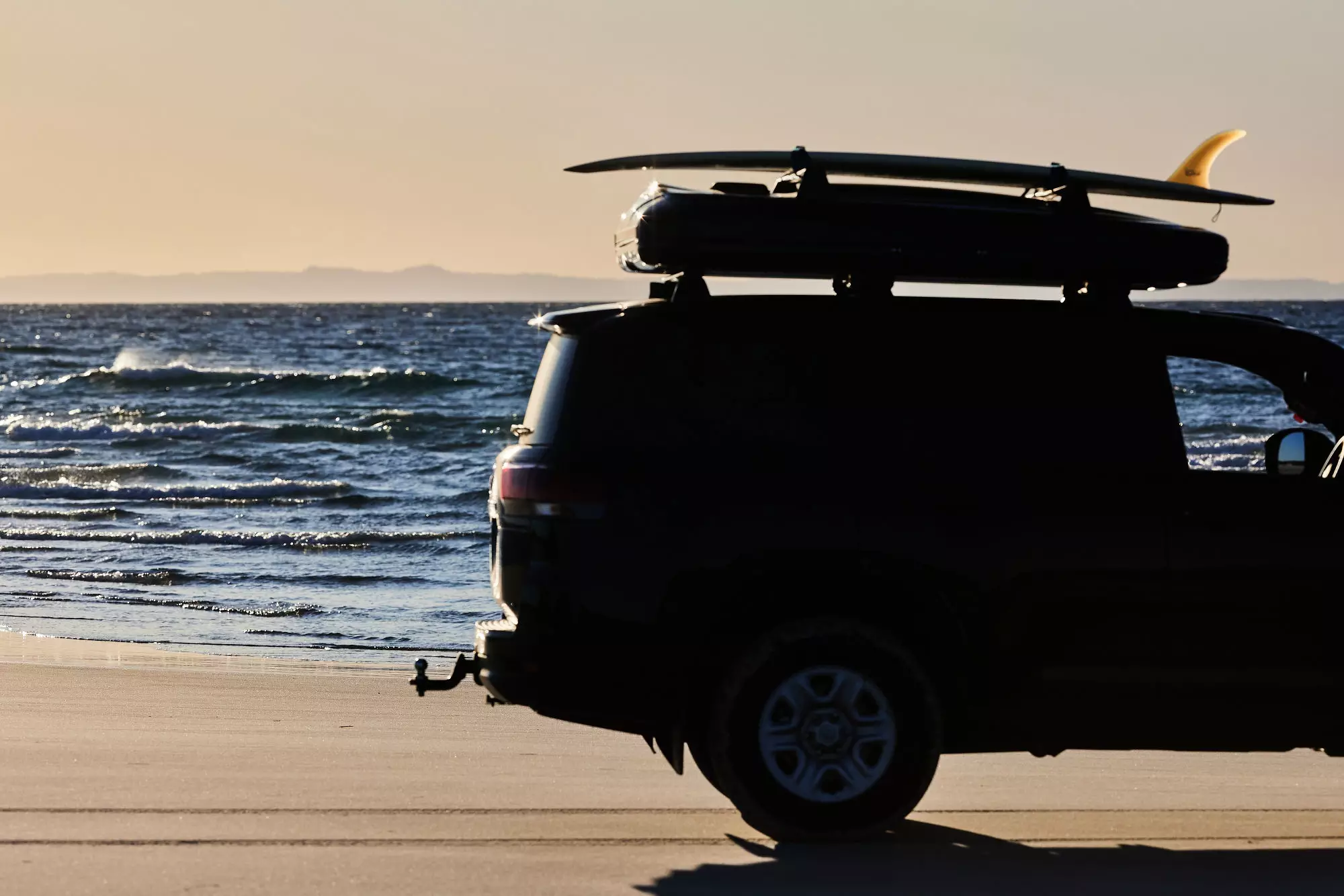 James Baroud Frontier Crossbars with a surfboard on top