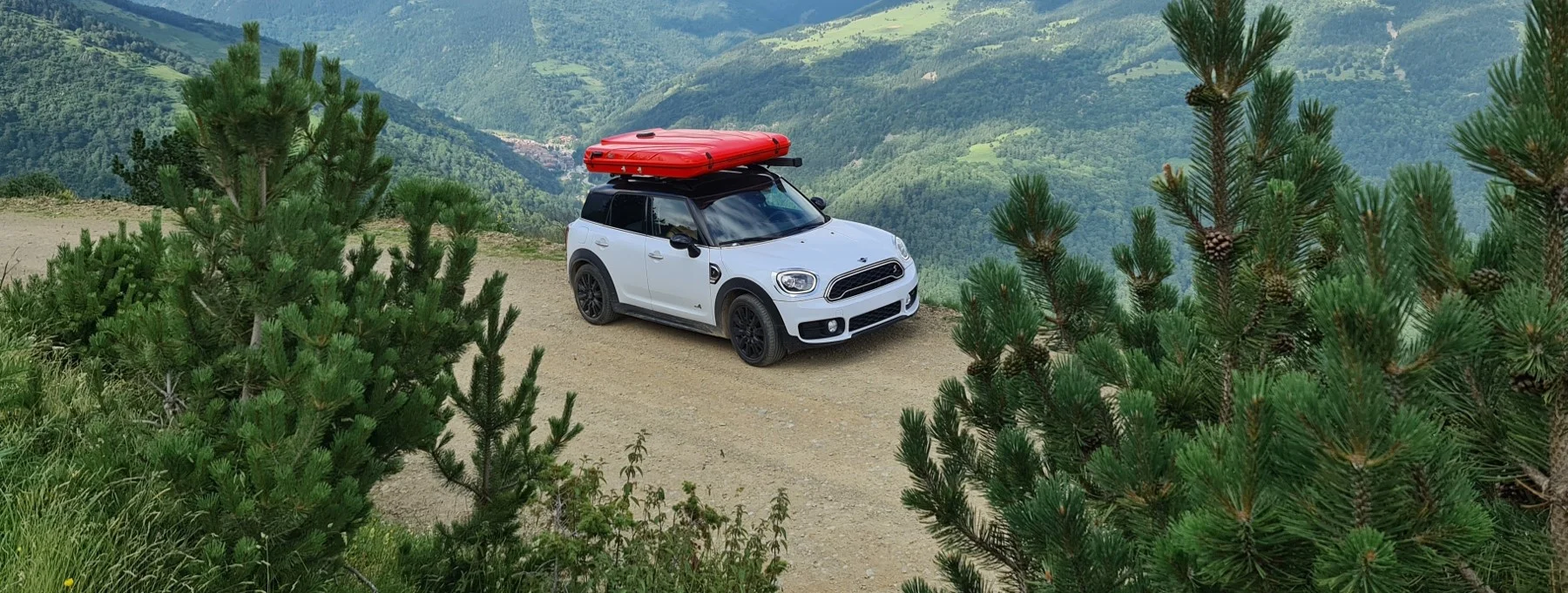 Dream Fontanilles red Evasion rooftop tent on top of a white Mini Cooper